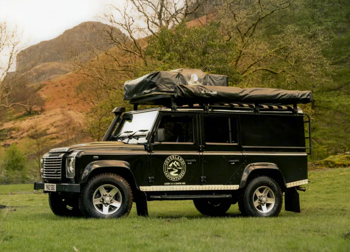 Black Land Rover Defender rv rental, a luxury 4x4 camper with roof tent, ready for scenic overland adventures.. Land Rover 2013 Land Rover Defender 110 XS Utility + 1 Roof Tent 2016
