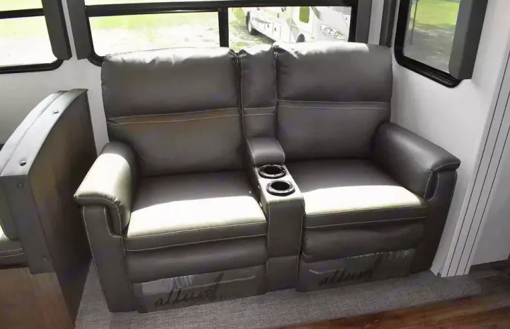 Comfortable grey reclining seats with cup holders inside an RV, perfect for your next RV rental road trip.. Keystone Cougar 2021