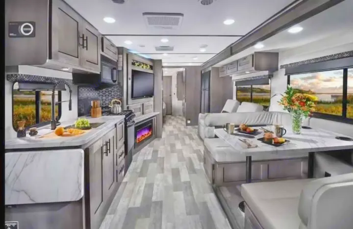 Explore this modern rv rental interior, featuring a well-equipped kitchen, comfy dining booth, and relaxing living space.. FR3 FR3 Motorhome 2023