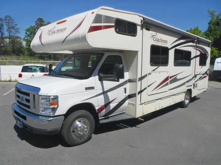 White Coachmen Freelander Class C motorhome, perfect for your next rv rental. Parked outside on a sunny day.. Coachmen Freelander 2018