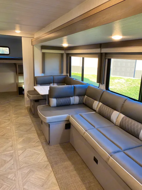 Spacious RV rental interior with comfortable U-shaped dinette, perfect for relaxing after a day of travel.. Forest River Salem 2024