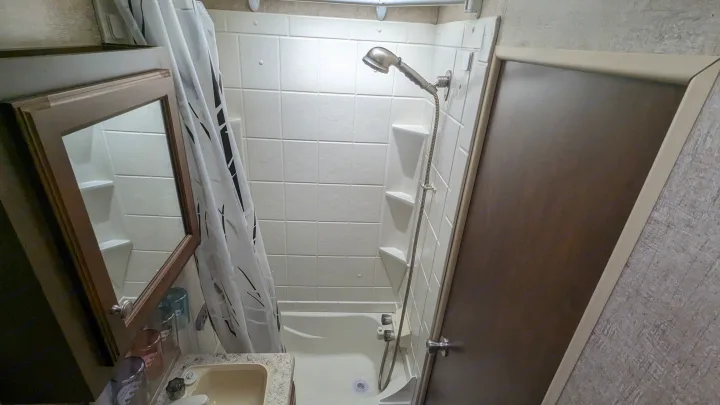 RV rental: A compact bathroom with a tub/shower, sink, and vanity mirror, perfect for your travel needs.. Sonic Lite 2016