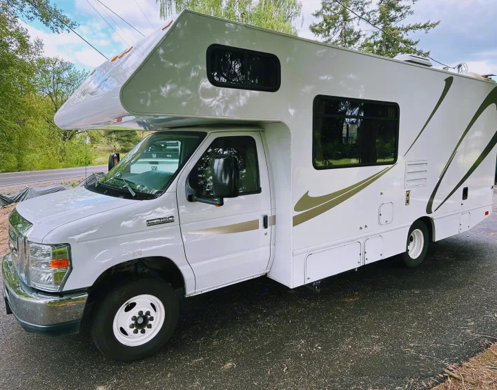 A clean, white Class C Ford E-350 RV rental, ideal for road trips and outdoor getaways.. Thor Majestic 2015
