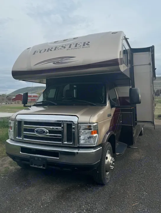 Tan Forester Class C RV on Ford chassis. Perfect for an rv rental, parked on gravel in a scenic setting.. Forest River 3051S Ford 2017