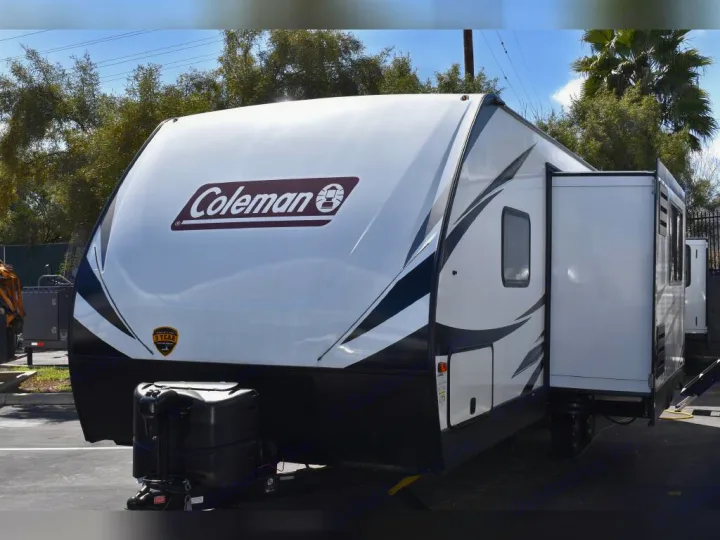 This white Coleman travel trailer is available for RV rental. Features a large side slide-out for more space.. Dutchmen Coleman Light 2021