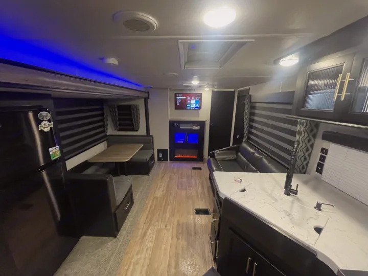 Explore this spacious rv rental! Features a modern interior with blue LED lights, a full kitchen, dinette, and sofa.. Forest River Cherokee 2021