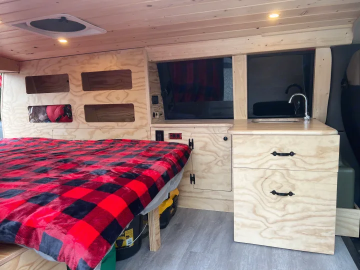Interior of a wood-paneled camper van, perfect for an rv rental.. Gmc Savanna 2010