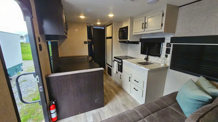 This RV rental features a modern interior with kitchen, dinette, and sofa, offering a comfortable living space.. Jayco Jay Flight Baja Edition 2023