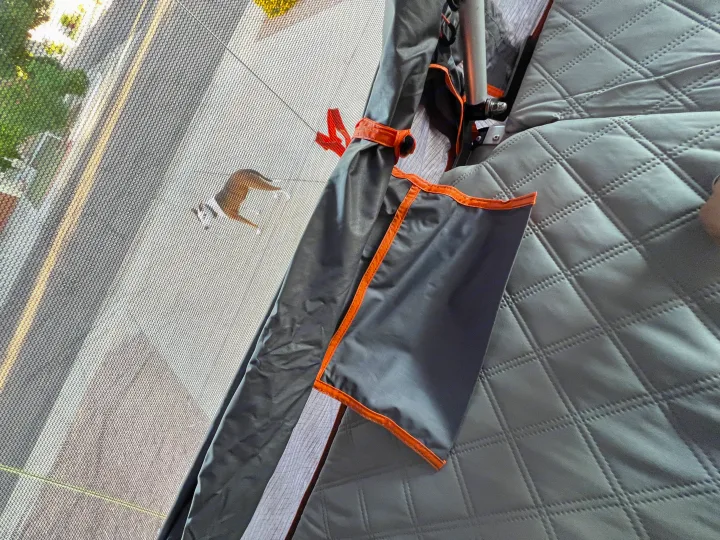 RV rental: Inside, looking out through the screen at a dog on the road, with quilted grey interior.. Ady ORT 2022