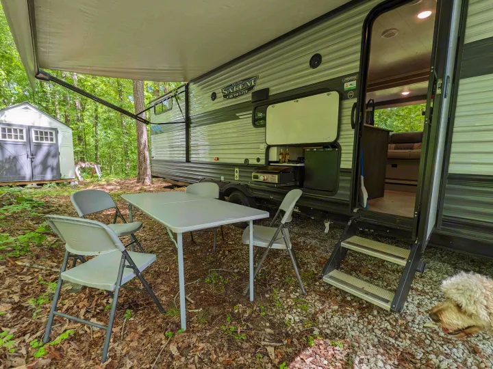 RV rental perfect for outdoor living: large awning, full outdoor kitchen, dining table, and a furry friend.. Forest River Salem Cruise Lite 2022