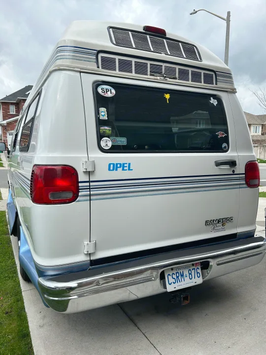 White Ram 3500 Roadtrek camper van with an Ontario plate, ideal for an RV rental adventure.. Roadtrek 190 Popular 1997