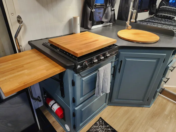 Compact RV rental kitchen features gas stove, wood countertops, and smart storage for travel.. Four Winds Majestic 2008