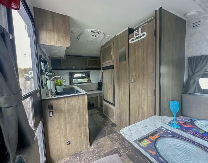 Bright and cozy rv rental interior, showcasing a compact kitchen, dinette, and ample storage for an enjoyable road trip.. Prolite Evasion 2021