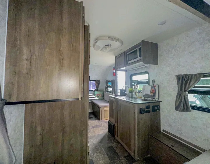 This rv rental features a well-appointed kitchenette with a sink and microwave, plus a comfortable dinette area for enjoyable trips.. Prolite Evasion 2021