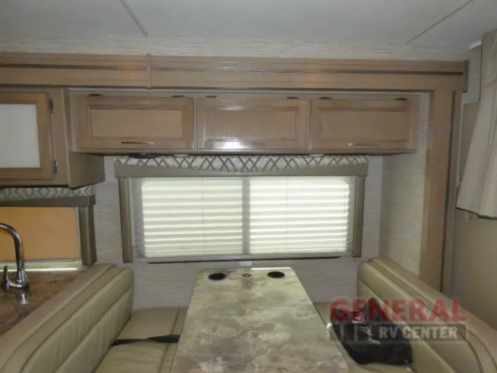 RV rental: Cozy dinette with a table, benches, window, and overhead storage cabinets.. Thor Quantum SE 2022