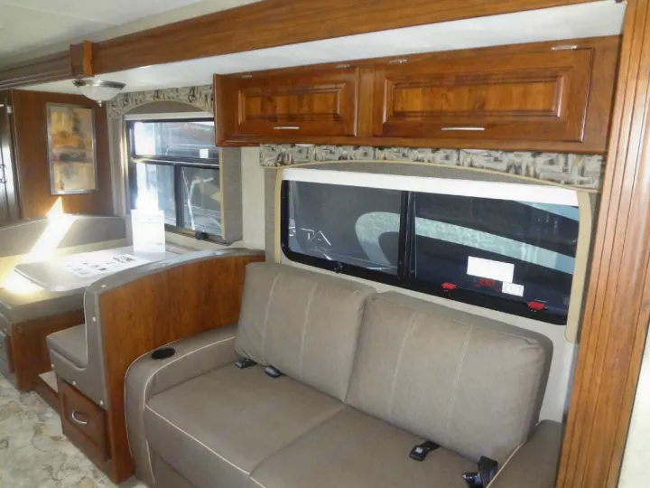 Cozy RV rental interior with dinette and sofa, ideal for travel adventures and comfortable living on the road.. Thor Quantum SE 2022