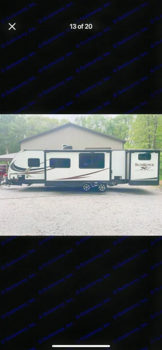Spacious white Sundance RV travel trailer for rv rental, parked on gravel with slide-out extended. Ready for your next trip!. Heartland RVs Sundance XLT 2016