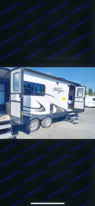White Imagine travel trailer RV with open doors & steps, ready for your next RV rental adventure.. Grand Design Imagine 2018