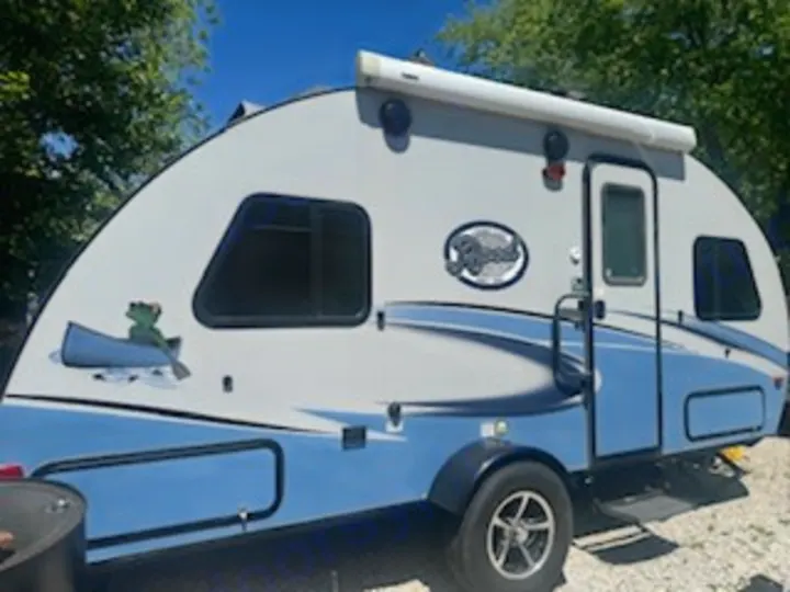 Explore nature! This charming light blue & gray travel trailer, with a frog-in-canoe decal, is an ideal RV rental for camping.. R-Pod R-Pod Trailer 2018