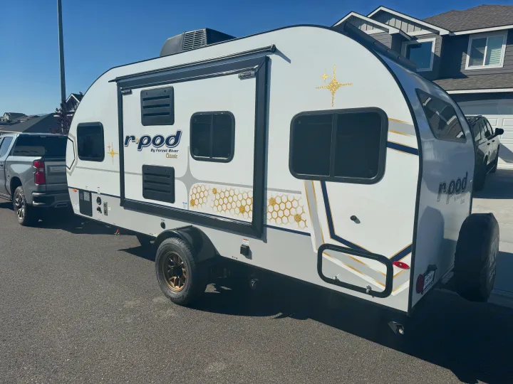 This Forest River R-Pod travel trailer, featuring golden honeycomb designs, is perfect for an rv rental adventure.. R-Pod R-Pod Trailer 2024