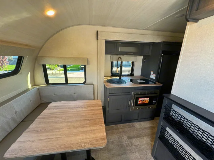 Spacious RV rental interior featuring a cozy dinette, modern kitchen, and practical storage solutions.. R-Pod R-Pod Trailer 2024