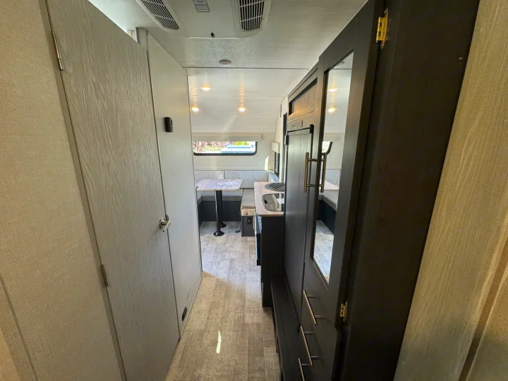 Step inside this bright RV rental, showcasing a compact kitchen, comfortable dinette, and functional hallway.. R-Pod R-Pod Trailer 2024