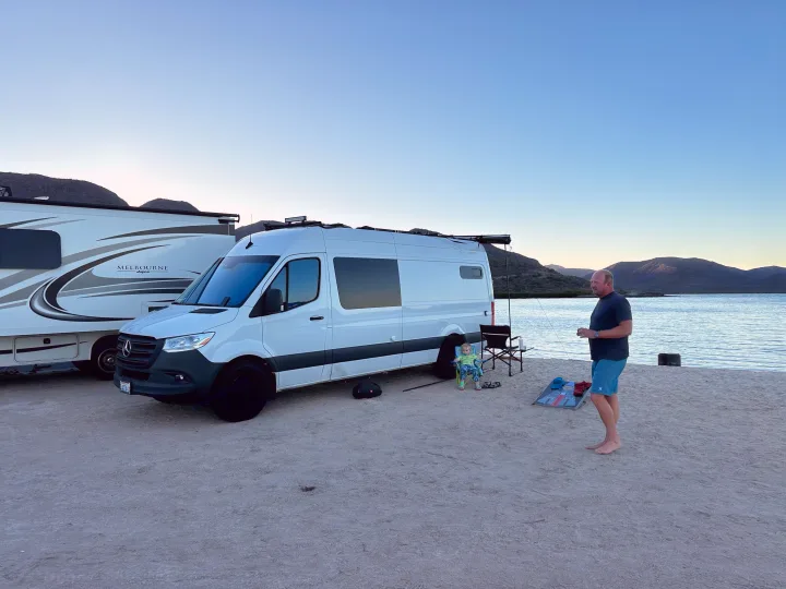 Family fun by the water with an RV rental and motorhome, enjoying beachside camping at dusk.. Mercedes-Benz Sprinter 2021