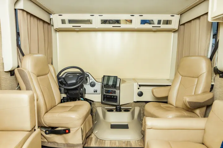 Inside this RV rental, comfortable driver & passenger captain's chairs, steering wheel, & modern dashboard.. Thor A.C.E. 2023