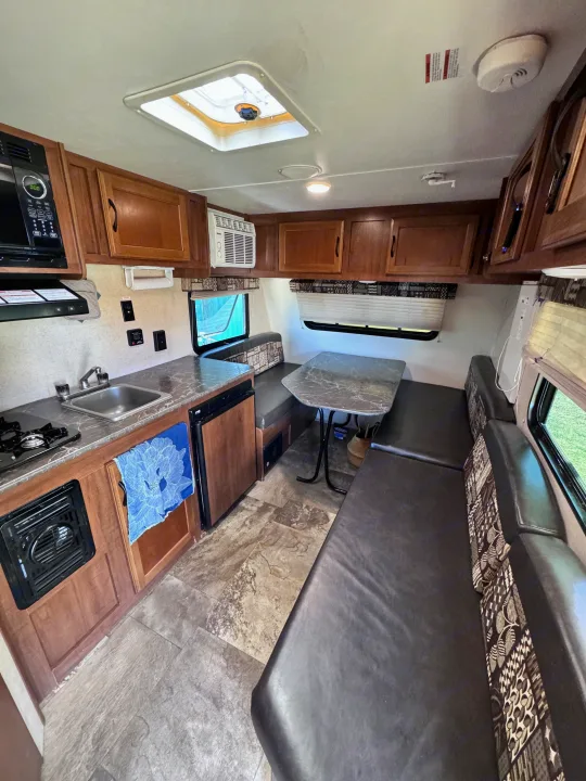 Explore this RV rental's compact interior with a full kitchen, dining area, and cozy seating. Perfect for road trips!. Jayco Jay Flight SLX 2016
