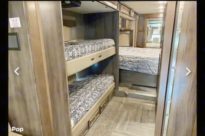 Explore this RV rental's versatile interior: cozy bunk beds (350lb capacity) and a comfortable master bedroom.. Fleetwood Discovery LXE 2020