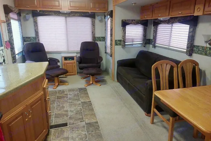 RV rental: Bright interior with kitchen counter, recliners, sofa, and dining area for comfortable travels.. Crossroads Silverado 2005
