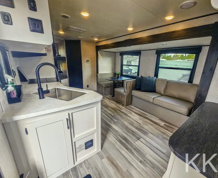 Modern RV rental interior with kitchen, dinette, and living area. Perfect for travel!. Highland Ridge RV Open Range 2024