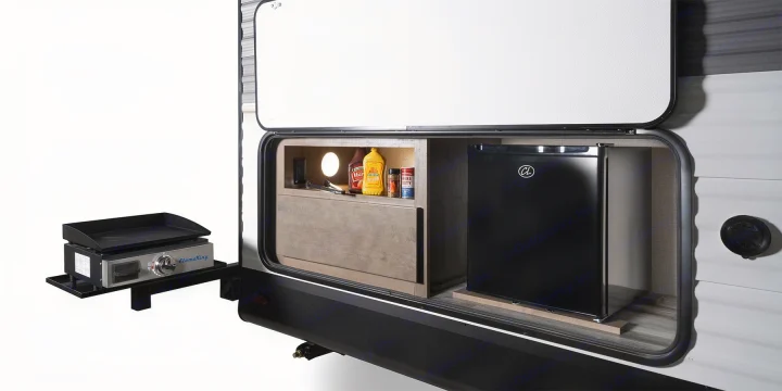 RV rental with convenient outdoor kitchen: pull-out griddle, mini-fridge, and lighted condiment storage.. Highland Ridge RV Open Range 2024