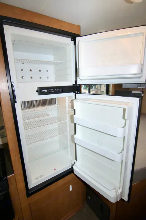 Clean, open RV rental refrigerator with separate freezer and spacious main compartment. Wire and door shelves ready for your groceries.. Winnebago Minnie Winnie 2016