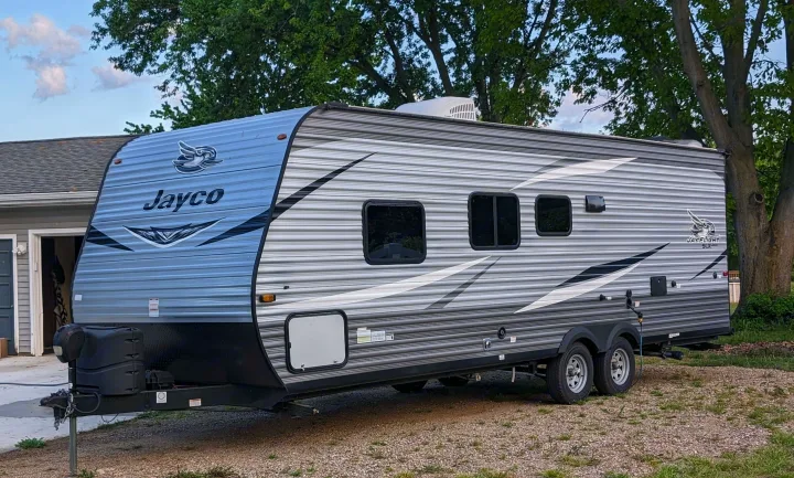 Jayco travel trailer RV rental, sleek and modern, parked and ready for your camping adventures.. Jayco Jay Flight SLX 2021