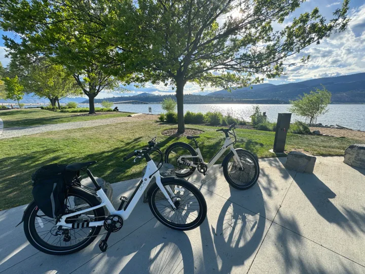 Two white electric bikes parked by a sunny lake, ready for exploration with your RV rental.. Ebike 500 Watt 2024