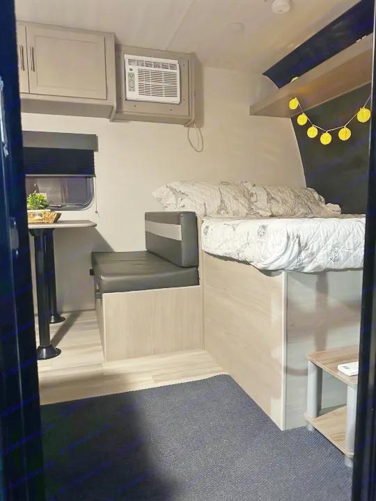 Step inside this cozy RV rental: a comfortable bed, dinette, AC, and storage cabinets. Perfect for your next travel adventure.. Keystone Springdale 2024