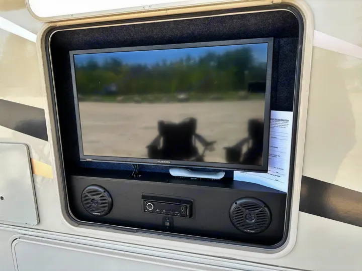 This RV outdoor entertainment bay features a TV and Furrion audio system with speakers, perfect for your next rv rental adventure.. Coachmen Leprechaun 2019