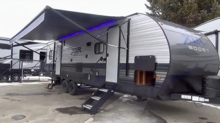 Spacious gray & silver travel trailer RV, with extended awning, blue LED lights, and easy access steps, perfect for your next rental.. Forest River Xlr Thunrderbolt 2022