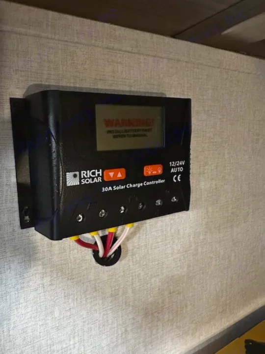 RV rental: Black 30A Rich Solar charge controller warns 'INSTALL BATTERY FIRST'. Critical for off-grid power setup.. Coachmen 2146BHX 2023