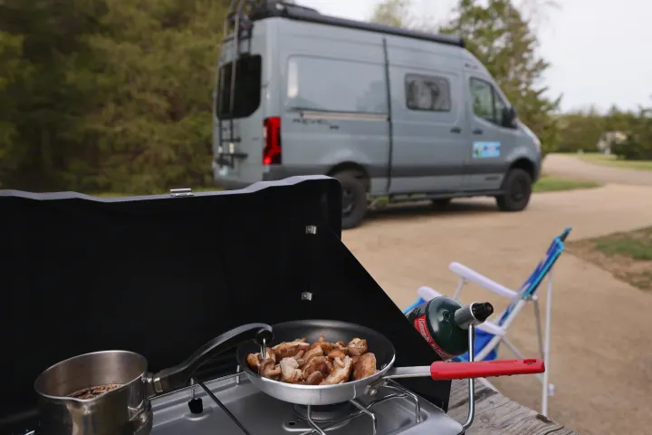 Outdoor cooking by an RV rental: mushrooms sizzling, coffee brewing, ready for adventure.. Mercedes Winnebago Revel 2023