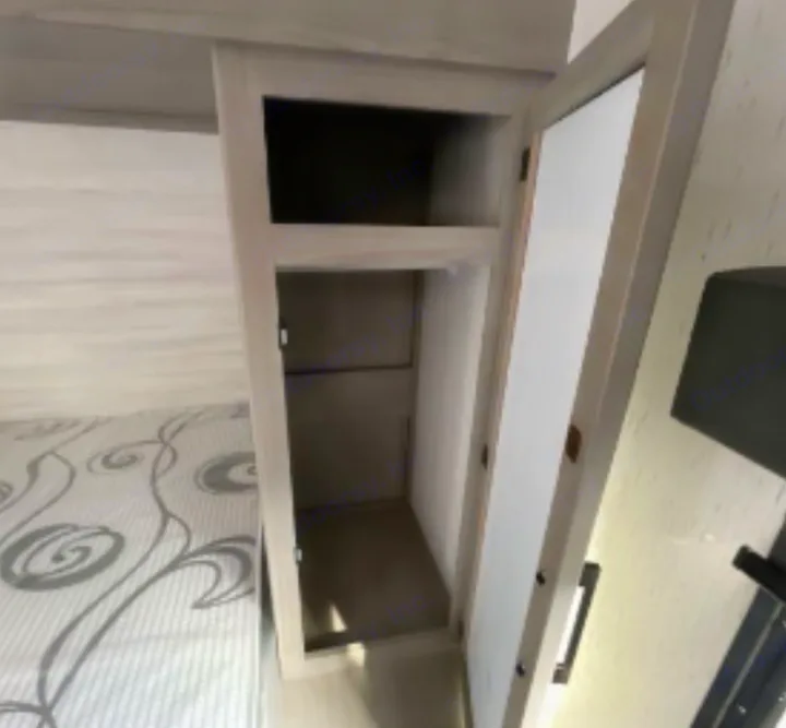 Inside this RV rental: a cozy bunk bed next to smart storage with shelves. Perfect for compact living and travel.. Dutchmen Kodiak SE 2023