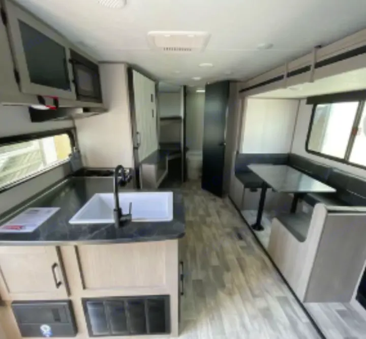 Spacious RV rental interior with modern kitchen, dinette, and bathroom. Perfect for travel adventures.. Dutchmen Kodiak SE 2023