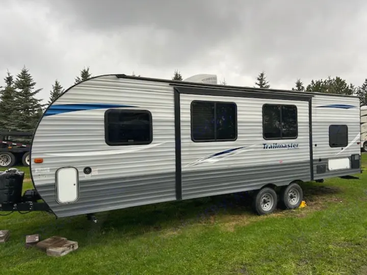 A grey and blue Trailmaster travel trailer, set up for an RV rental. Ideal for camping & outdoor adventures.. Gulf Stream Trailmaster 2018