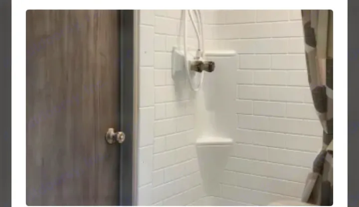 RV rental: Bright, modern shower with white subway tile walls, handheld showerhead, and nearby door.. Coachmen Catalina Legacy 323BHDSCK 2022