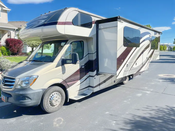 This Sunseeker motorhome, ideal for rv rental, is parked with its slide-out extended on a sunny day.. Forest River Sunseeker MBS 2016