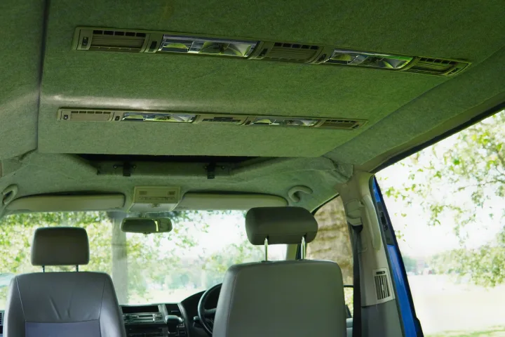 Experience the well-appointed interior of an RV rental, showcasing overhead lighting, air vents, and front cabin views.. Volkswagen Other 2006