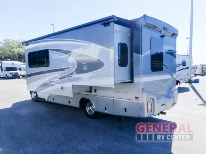 A large, modern silver RV motorhome, with its side slide-out extended, is parked outdoors. Ideal for rv rental trips.. Entegra Coach Qwest 24L 2024