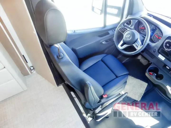 Experience comfort in this RV rental's modern Mercedes cockpit. Features a plush blue driver's seat & clear dashboard.. Entegra Coach Qwest 24L 2024