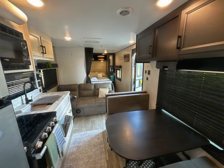 Modern RV rental interior featuring a kitchen, living area, and bedroom. Ideal for your next road trip adventure.. Jayco Jay Flight 2023